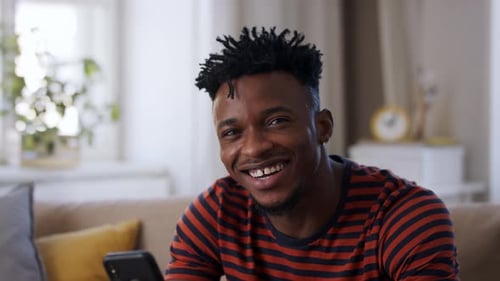 Smiling Man Using Smartphone Indoors Close Up