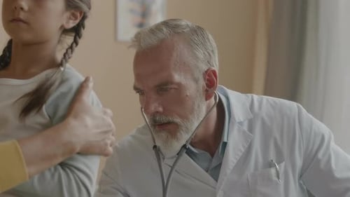 Doctor Listening to Child Heartbeat with Stethoscope