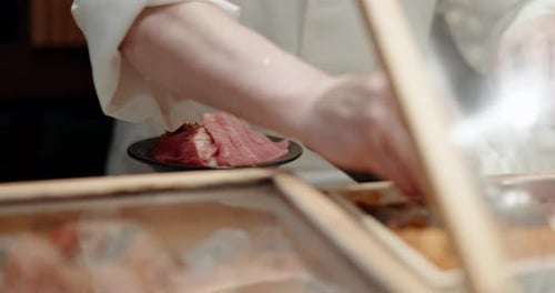 Cooking, hands and chef in a restaurant with catering, fish and Japanese dish in a kitchen