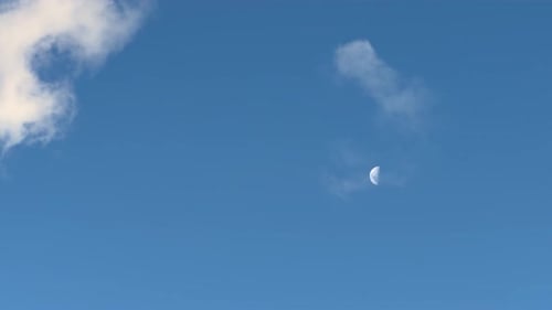 Blue Sky and Clouds with the Moon Visible