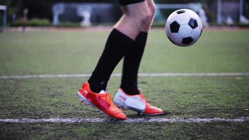 Soccer Player Juggling Ball on Field