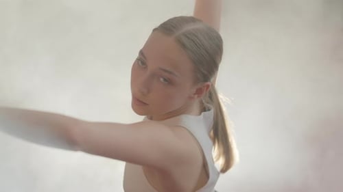 Young Woman Dancing in Smoky Studio