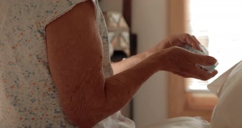 Senior Woman Taking Pills From Pill Organizer
