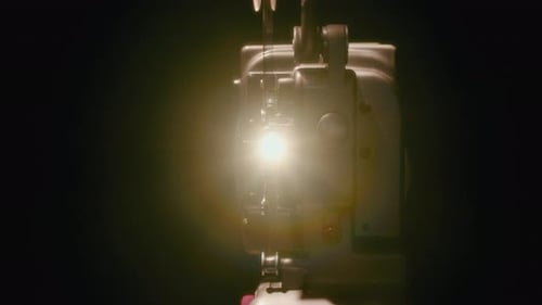 Vintage Film Projector Shining in the Dark