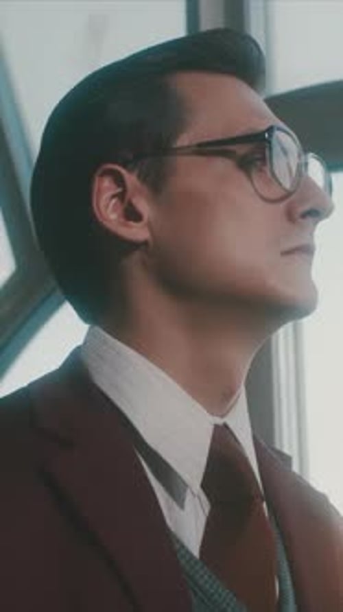 Portrait of a Handsome Young Clever Scientist in a Classic Suit Looking Pensively Through the Window