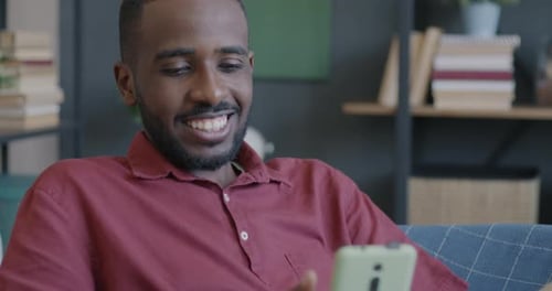 Man Talking on Phone Video Call at Home