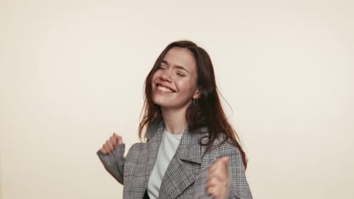 Woman Dancing and Smiling in Studio
