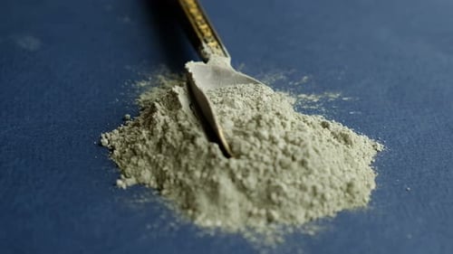 Close Up Green Clay Powder Rotates on Black Background