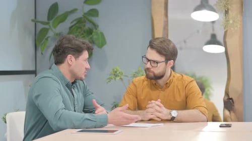 Businessmen Discussing Project at Office Table
