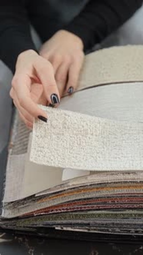 Close up of Woman's Hands with Fabric Samples