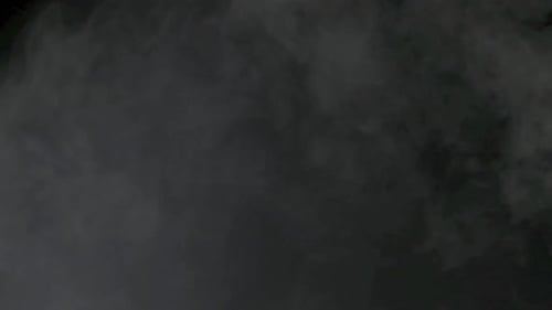 Slow motion of white smoke, fog, mist, vapor on a black background.