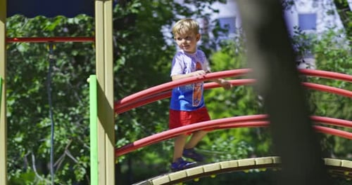 A Happy Child Slides Down a Childrens Slide in a Childrens Park