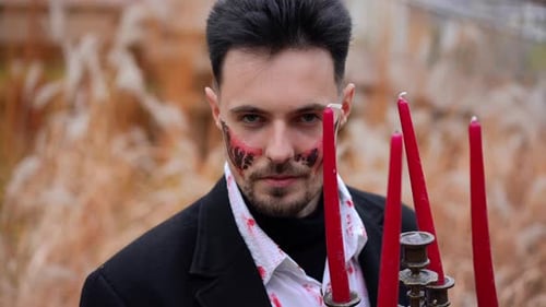 A Mysterious Figure Among Flickering Candles Creates an Intriguing Eerie Atmosphere