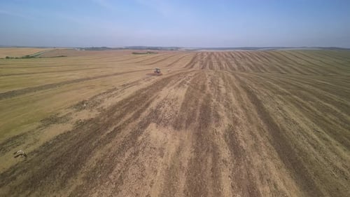 Tractor working on the field doing tillage with cultivator