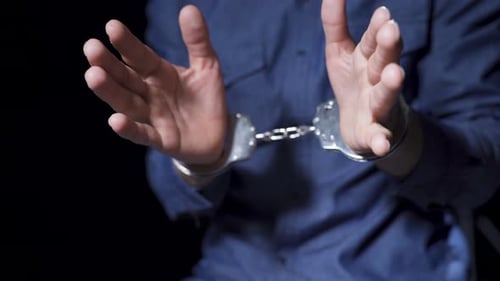 Prison, guilty man, handcuffs.