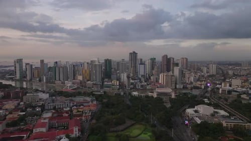 Aerial Panoramic Footage of High Rise Buildings in Modern Urban Borough on Riverbank Clouds in