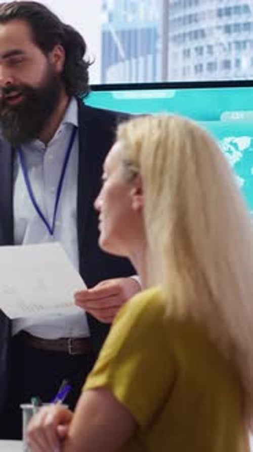 Vertical Video Financial Advisor Showing Statistical Graphs on Big Screen to Customers