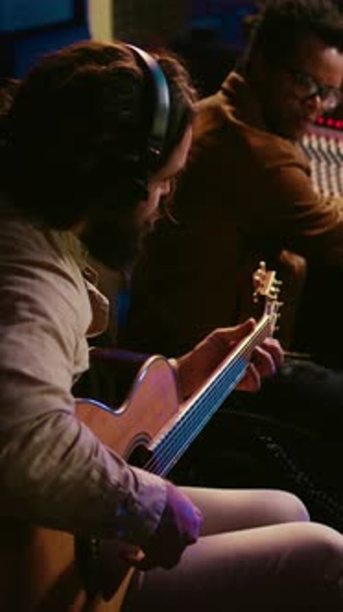 Vertical Video Talented Guitarist Doing Live Performance in Professional Studio