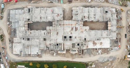 Top View Aerial Flight Over New Commercial Building Under Development with Employed Union Constructi