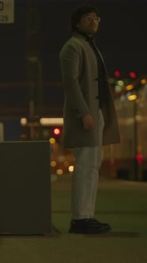 A Lonely Nighttime Reflection Captured Beautifully at a Bus Stop Under the City Lights