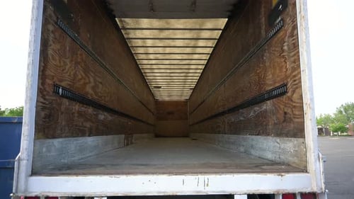 Looking into an empty white semi truck cargo trailer before receiving packages, static