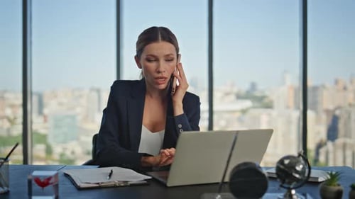 Businesswoman Talking on Phone in Modern Office