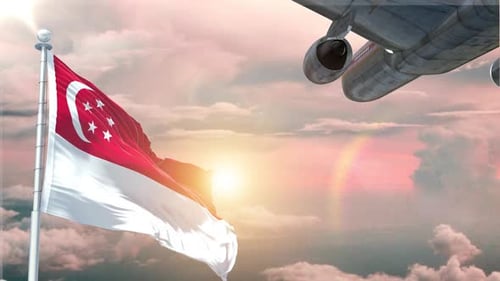 Waving Singapore Flag and Airplane Flying at Sunset