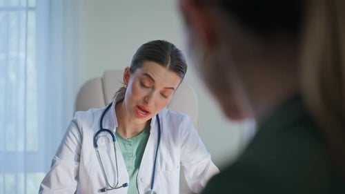 Female Doctor Talking to Patient in Office