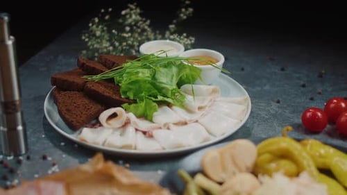 Plates of food arranged beautifully on dark surface