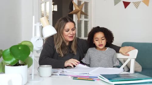 Woman and Child Working on Homework at Home