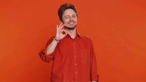 Smiling Man Gives OK Hand Gesture in Studio