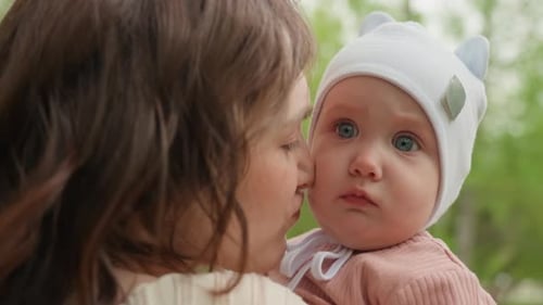 Gentle Touch In Park Mom Shares Tender Moment Outdoors Heartwarming Scene Of Mother Tenderly Kissing