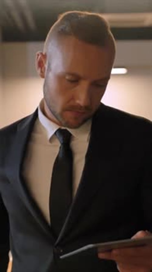 Vertical of Young Successful Man at Evening Business Center