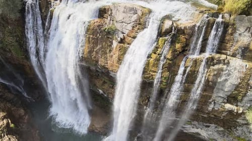 Powerful Waterfall Cascading Down Rocky Cliffside