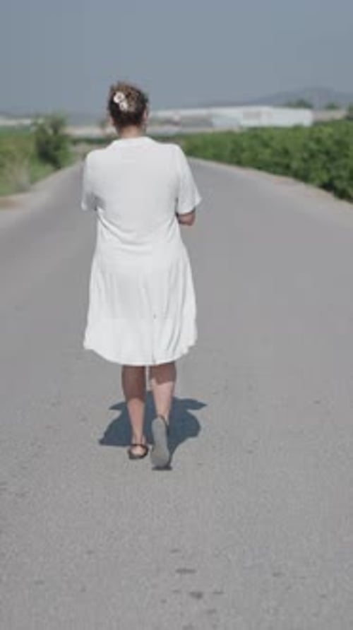 Woman Walking Rural Road Drinking Water