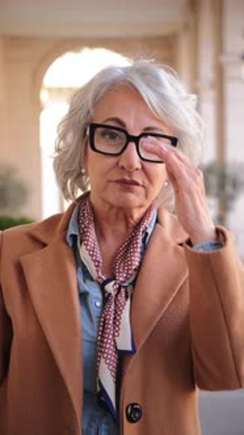 Stylish Senior Woman Posing Confidently in Urban Setting