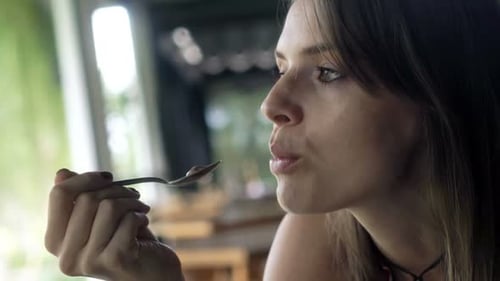 Beautiful Woman Eating Tasty Ice Cream Sitting in Cafe 30s