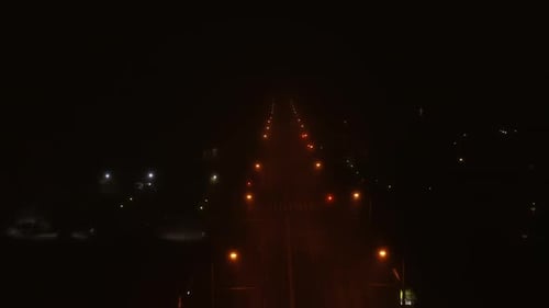 Aerial Foggy Road and Street Lights at Night with an Empty Road in Romania, Cluj-Napoca. Spooky Nigh