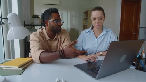 Biracial Colleagues Working in Office of Startup