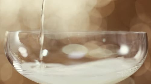 Pouring Champagne into an Elegant Glass