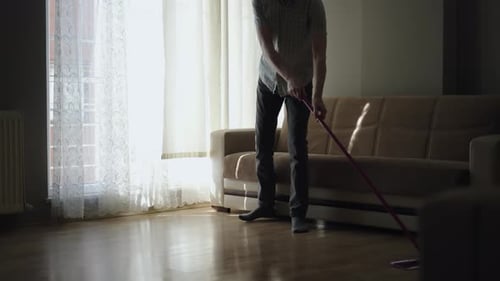 Adult Mopping the Floor at Home