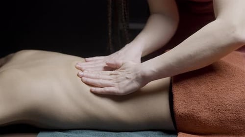 Close Up of Professional Masseuse Massaging Back and Shoulders of a Female Client