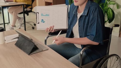 Analyst Presenting Charts in a Corporate Office