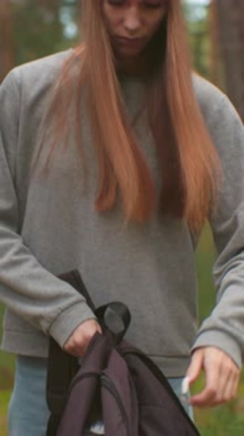 Young Hikers Walking Through Tranquil Forest Preparing for Outdoor Break