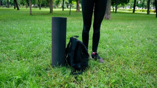 Fitness equipment on green grass on a sunny day yoga mat in the park Outdoor fitness concept sport