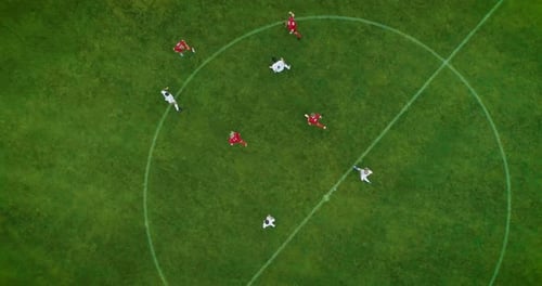 Aerial Top Down View of Soccer Field and Two Professional Teams Playing. Energetic Game in the Midd