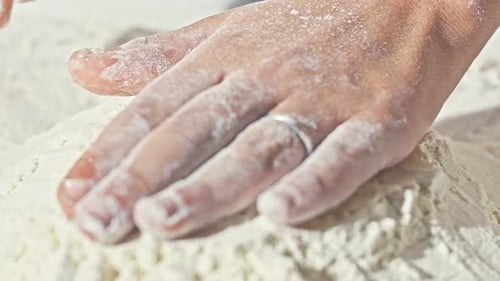 Close Up of Boy's Hands with Plain Flour Well and Eggs in Preparation Process for Baking Cooking
