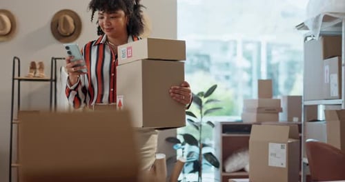 Designer woman, phone and boxes in workshop with contact, shipping app and reading notification