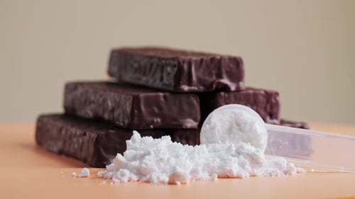 Vanilla protein powder in scoop and protein bars. Dietary supplement, nutrition, healthy energy.