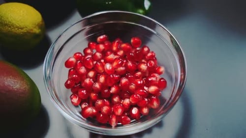 Pomegranate Seeds Lie in a Deep Glass Plate